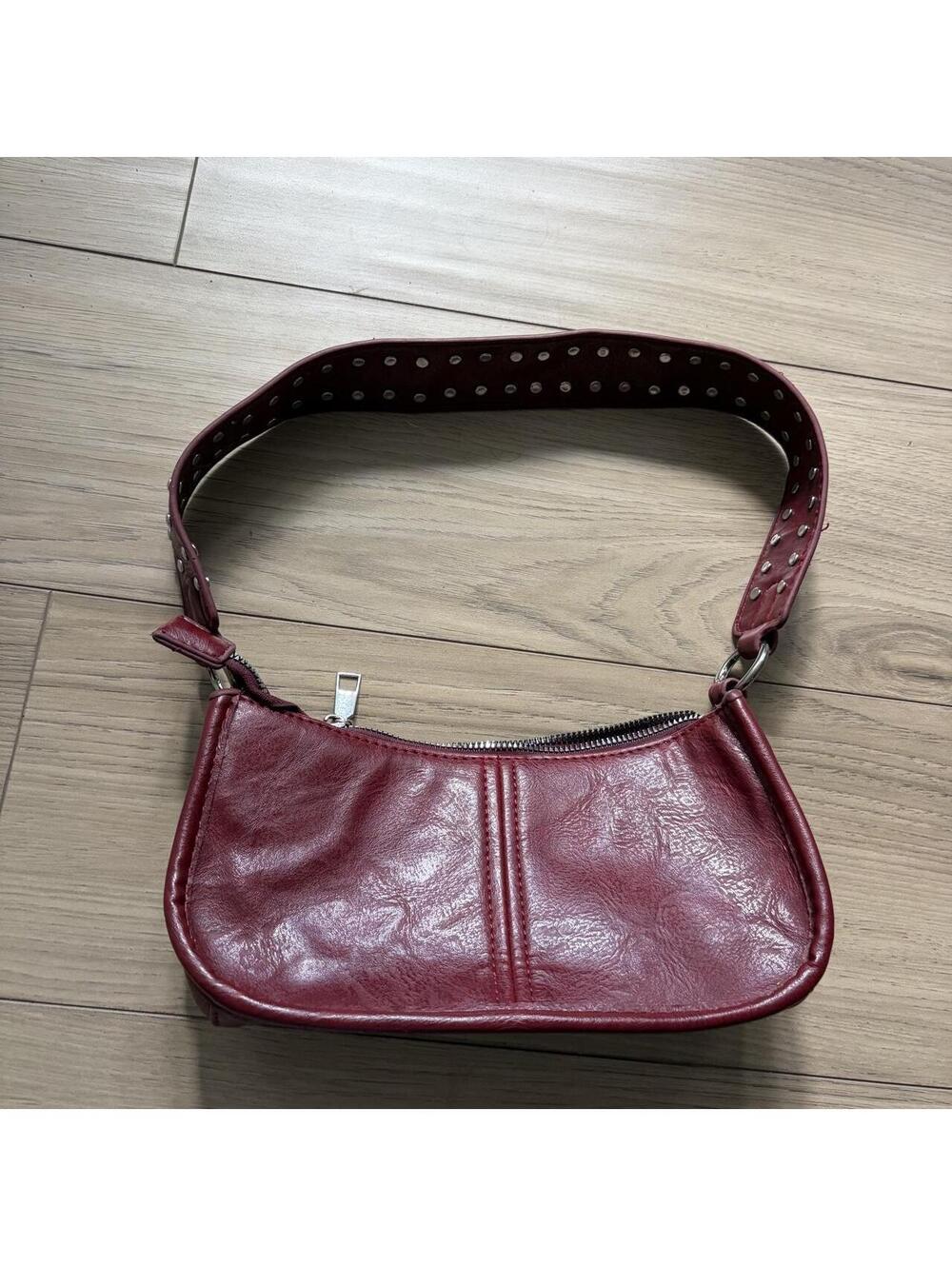 Burgundy leather crossbody bag with studded strap